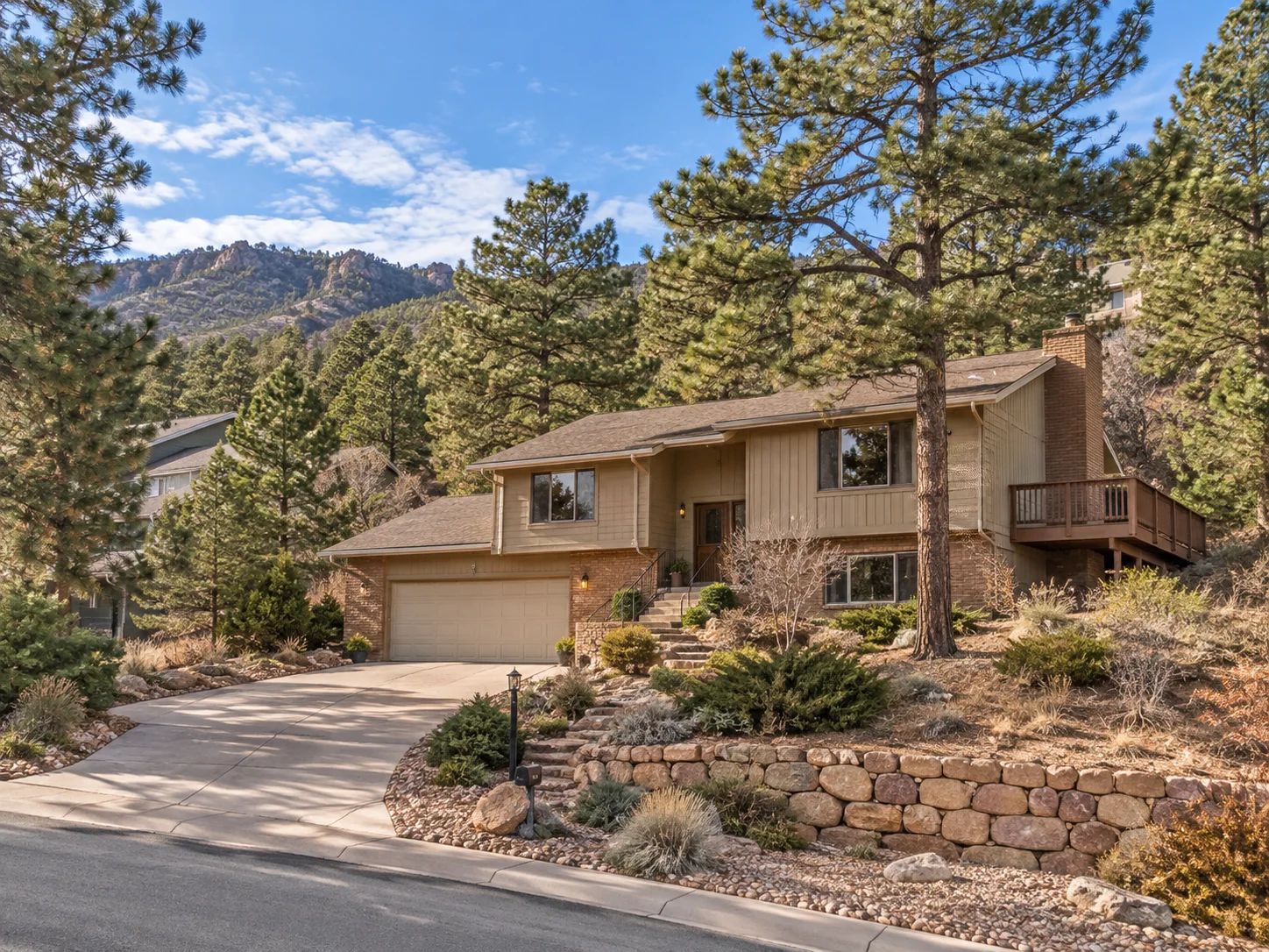 Established Rockrimmon Colorado Springs home on a sloped lot among mature pine trees