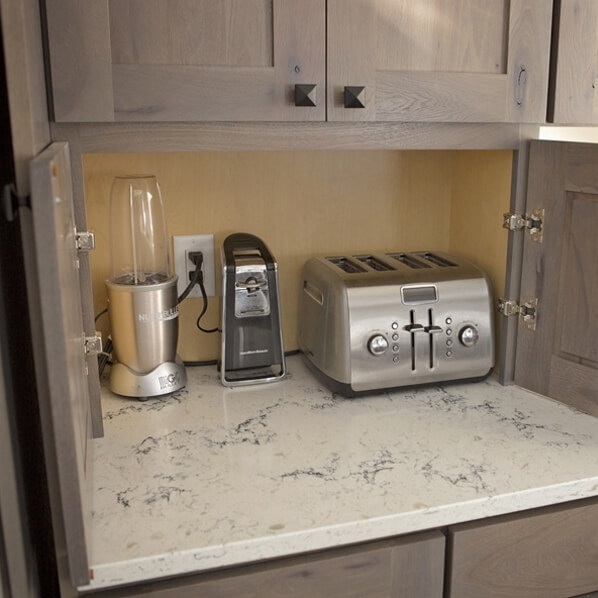 Appliance garage hides toaster, mixer and can opener